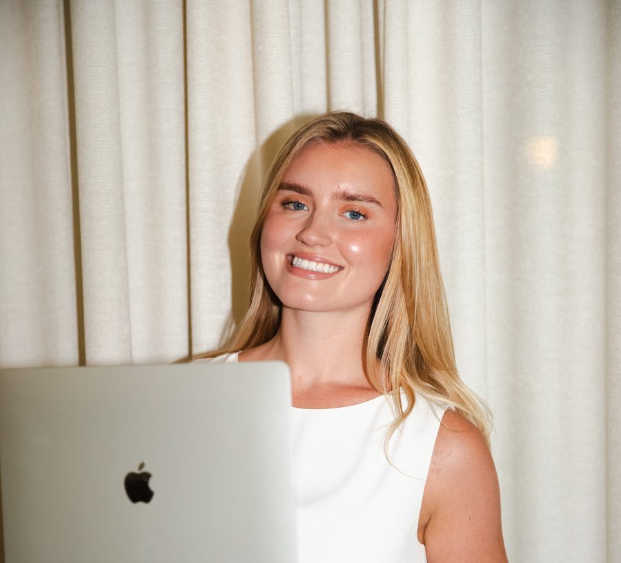 Lauren from Operations smiling over an open laptop