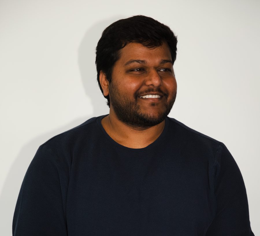 a teammate smiling and looking off camera